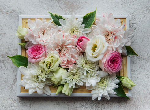 Wooden frame decorated with pink and white flowers