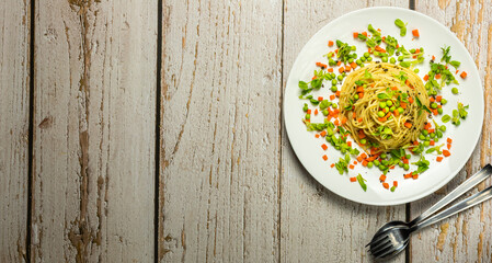 Homemade spaghetti with mixed vegetables. Healthy home food for vegetarian. Presenting with copy space from above.