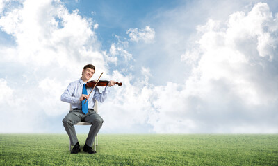 young businessman playing violin