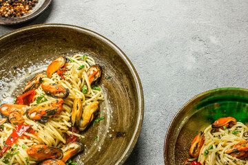 Homemade italian mussels spaghetti pasta with garlic and black pepper. Flavorful and comforting recipe. Presented with copy space, top view.