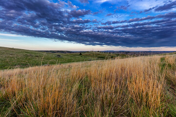 Little bluestem prairie grass and clouds in Theodore Roosevelt National Park, North Dakota, USA