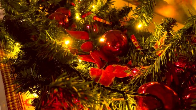 Christmas lights flashing on the Christmas tree filled with balls