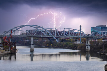 a shot of Cumberland river with the John Seigenthaler Pedestrian Bridge over the water surrounded...