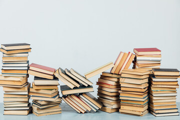 stacks of educational books for training in the college library as a background
