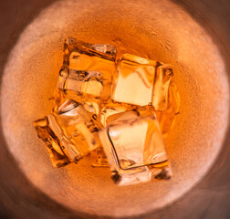 top view of alcohol glass with ice amber colored liquid Yes, at various parties and feast days