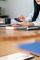 Woman hand using smartphone, vertical view. Business online communication.