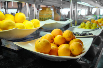 Smorgasbord in a cafe. Oranges and other fruits at buffet breakfast in a hotel restaurant. 