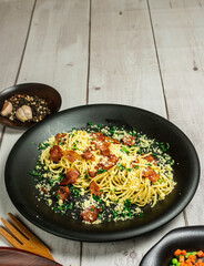 Spaghetti alla carbonara, This is a traditional Italian recipe for a quick dinner which consists of bacon, eggs, olive oil, basil and cheese.  Horizontal view from above and copy space.