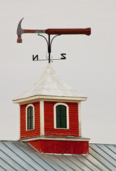 USA, New England, Vermont, Hammer weather vane atop a red barn