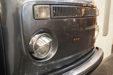 stylish old hippie minibus, front of a stylish old camper, headlights, radiator grille