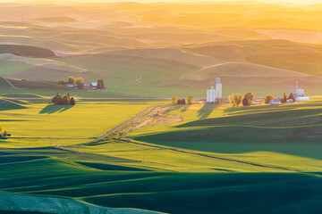 Steptoe Butte State Park, Washington State, USA. Sunset view of grain silos and wheat fields in the...