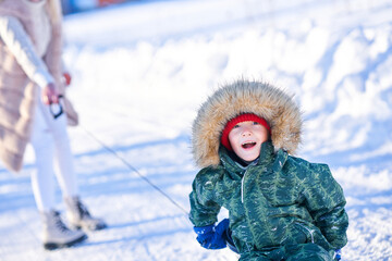 Nice happy family having fun on winter snow