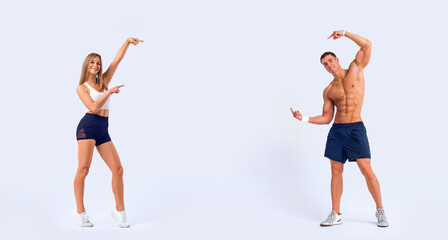 Fit couple at the gym shows on copy space isolated on white background . Fitness concept. Healthy life style.