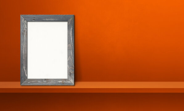 Wooden picture frame leaning on orange shelf. 3d illustration. Horizontal banner