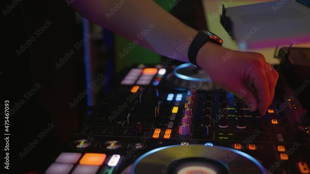 Poster a dj hands pushing a fader up and down on a dj console, static shot