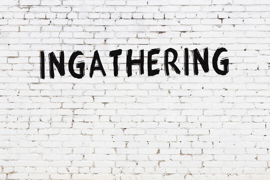 White wall with black paint inscription ingathering on it