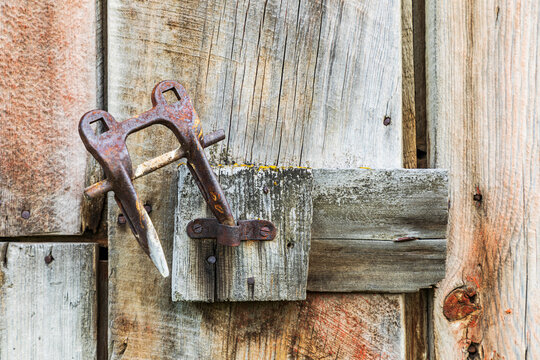 Latah, Washington State, USA. Rusted latch on a weathered old barn.