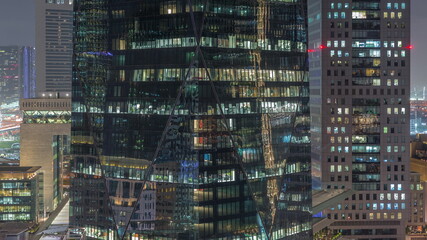Windows of office buildings at night timelapse, the light from the windows of houses