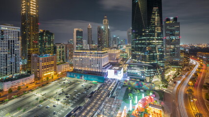 Fototapeta na wymiar Dubai International Financial district aerial all night timelapse. Panoramic view of business and financial office towers.