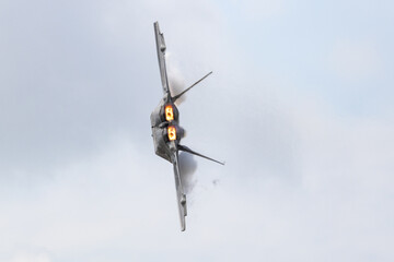 Lockheed F-22 Raptor performing at an airshow with full afterburner.