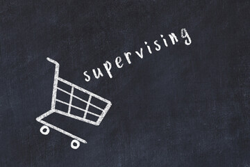 Chalk drawing of shopping cart and word supervising on black chalboard. Concept of globalization...