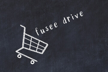 Chalk drawing of shopping cart and word fusee drive on black chalboard. Concept of globalization...