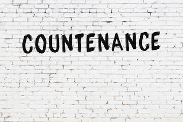 White wall with black paint inscription countenance on it