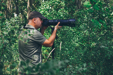 Wildlife photographer outdoor. Professional photographer in nature.