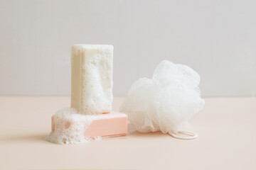 Natural organic handmade soap with large bubbles foam washcloth pastel background. Concept of using natural products 
