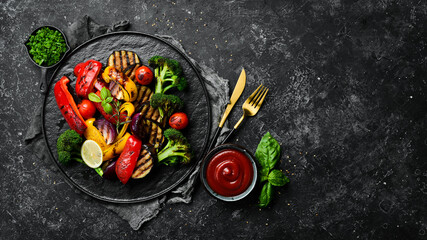 Grilled vegetables (colorful bell pepper, zucchini, eggplant, cherry tomatoes and broccoli) on a...