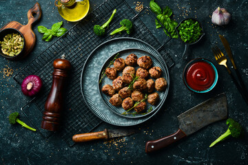 Homemade beef meatballs on a plate. Top view. On a stone background.