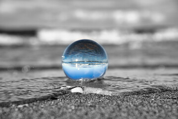 glass globe on the beach of the baltic sea.