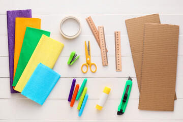 Materials for making Mexican pinata on white wooden background