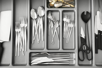 Open drawer with silver cutlery, closeup