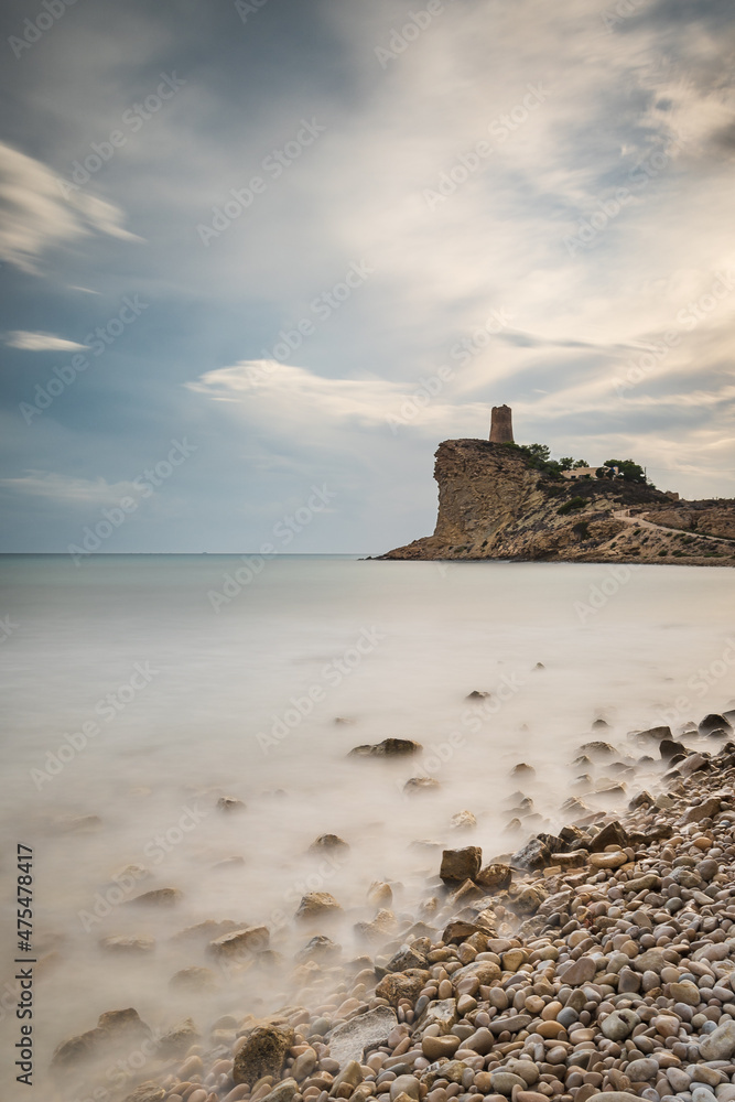 Sticker Scenic view of a rocky beach at sunrise