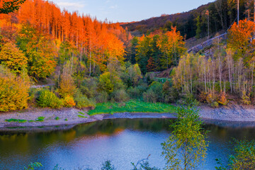 autumn sunset in the mountains with lake