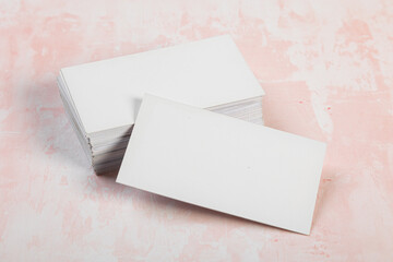 Blank business cards. Mock up on pink marble background. Copy space for text.