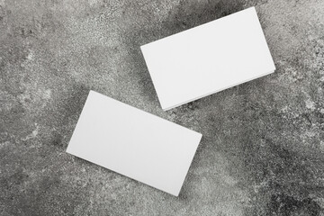 Photo of a stack of blank business cards on a stone table. Template for identity card.