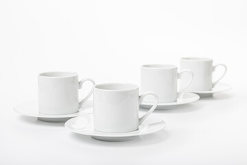 several white porcelain cup and saucer for coffee isolated on white background
