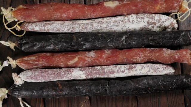 Traditional smoked sausage and sausages with mold. Salami sausage on a wooden board.