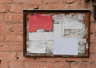 notice board with pasted margins for text on a brick wall background