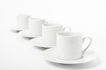 several white porcelain cup and saucer for coffee isolated on white background