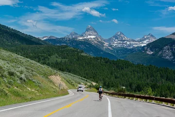 Foto auf Acrylglas Teton Range USA, Wyoming. Cyclist and car on highway with view of Grand Teton, west side of Teton Mountains