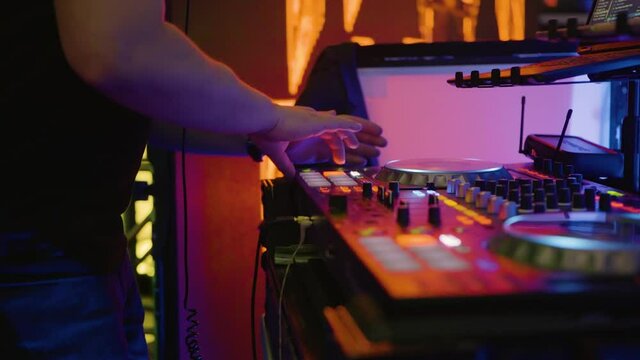 Professional EDM Disc Jockey Mixing Electronic Music Beat At Fundraising Gala