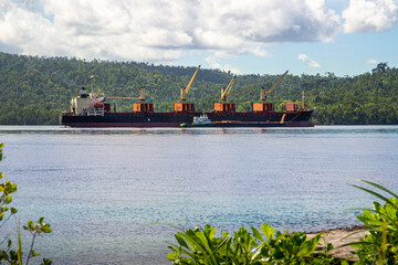 Logging ship and barge in Marovo Lagoon in the Solomon Islands. - obrazy, fototapety, plakaty