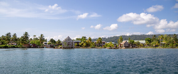 Waterfront houses in a village in Marovo Lagoon of the Solomon Islands. - obrazy, fototapety, plakaty