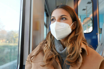 Close up of young lady wearing protective medical mask KN95 FFP2 on public transport looking...