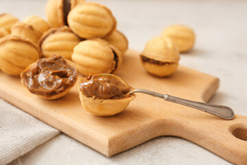 Tasty walnut shaped cookies with condensed milk on table