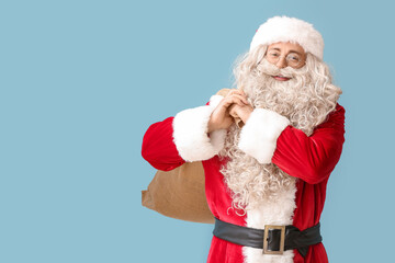 Santa Claus with sack bag on blue background