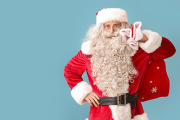 Santa Claus with red bag on blue background